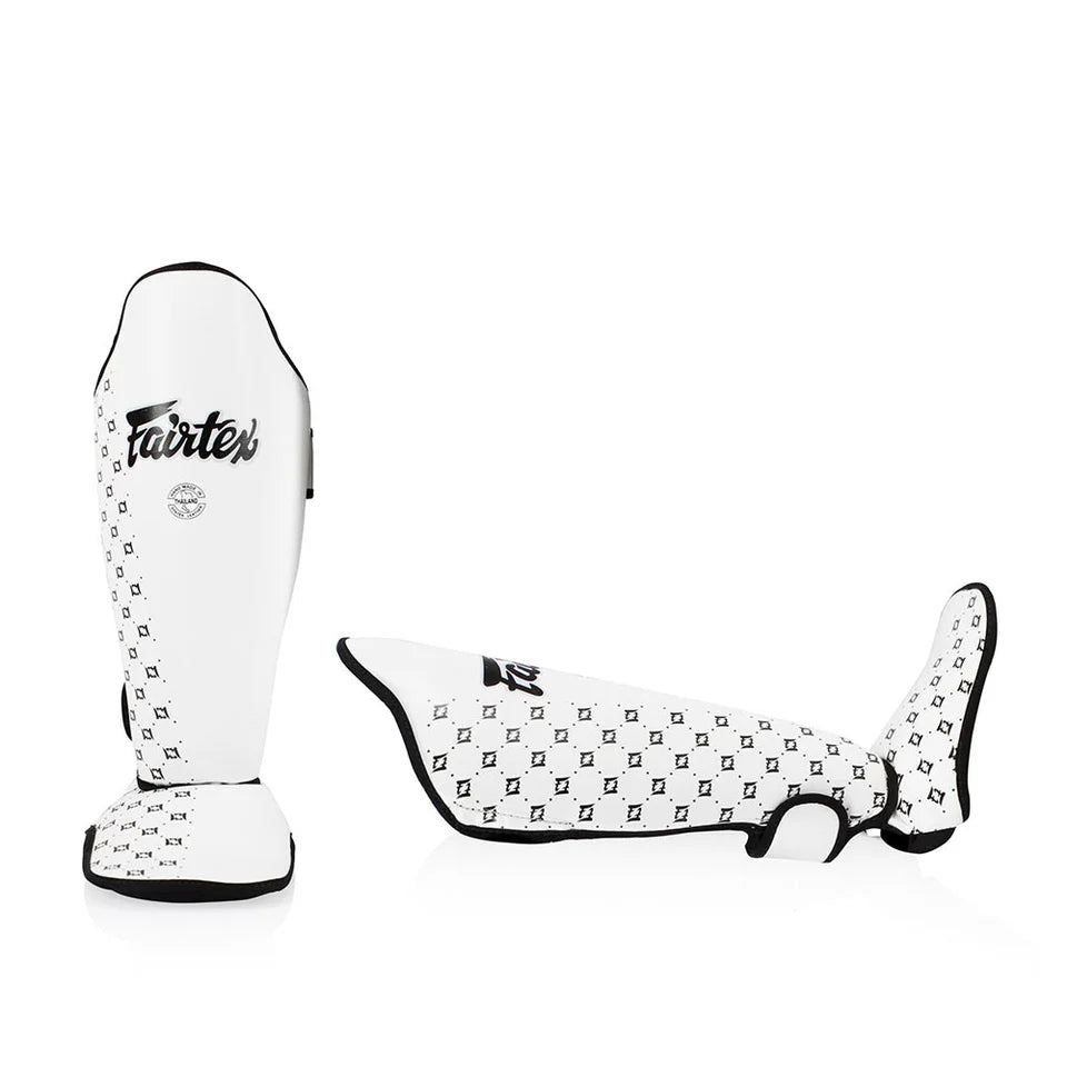 White shin guard with black pattern and 'Fairtex' branding on a white background