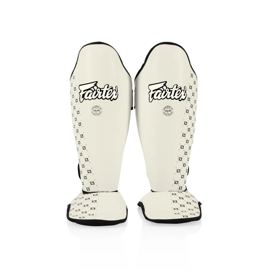 Pair of Fairtex shin guards on a white background