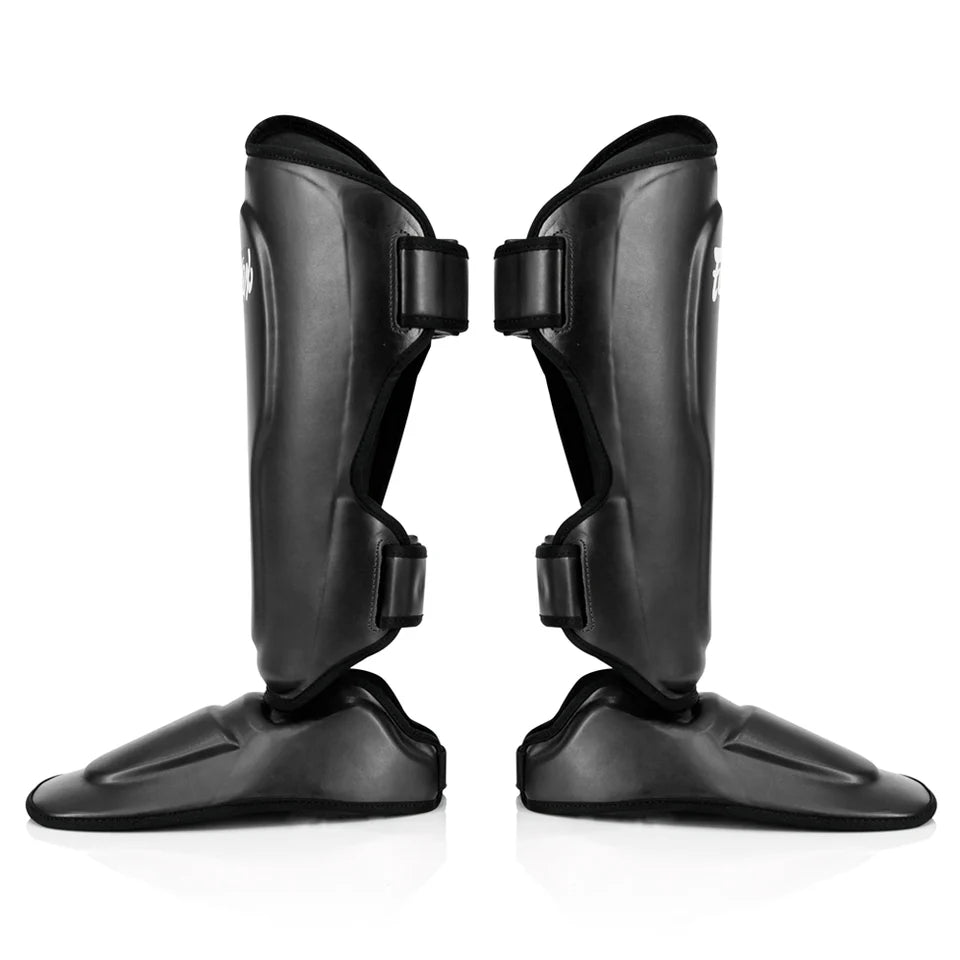 Pair of black shin guards on a white background