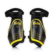 Pair of black and yellow Fairtex thigh pads on a white background