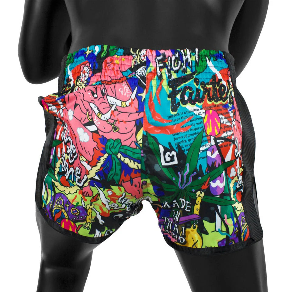 Colorful graphic Thai shorts on a black mannequin against a white background