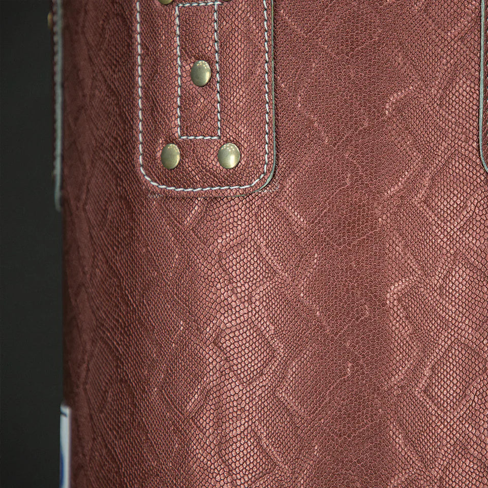 Close-up of a textured brown leather boxing bag with stitching details.