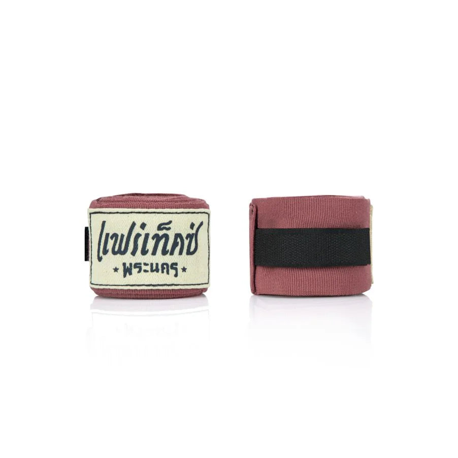 Pair of pink boxing hand wraps with a brand label on a white background