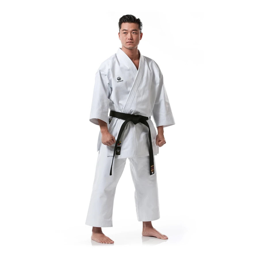 Person wearing a white Tokaido martial arts uniform with a black belt on a white background