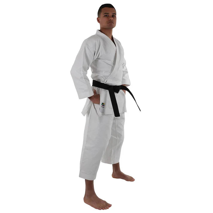 Male wearing a white martial arts gi with a black belt on a white background