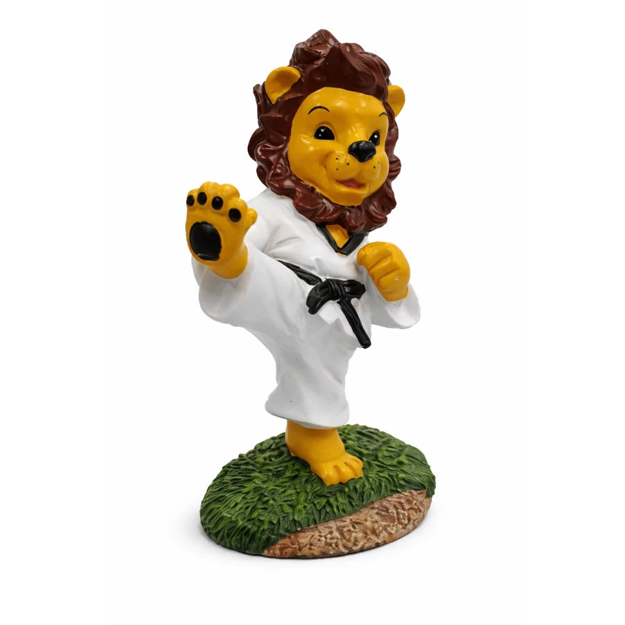 Lion figurine in a white martial arts uniform with a black belt on a white background