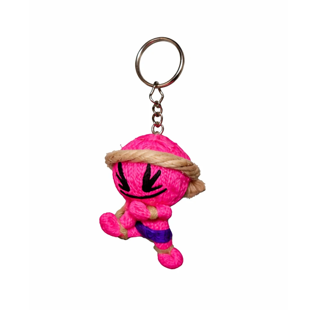 Pink plush muay thai keychain with a keyring on a white background