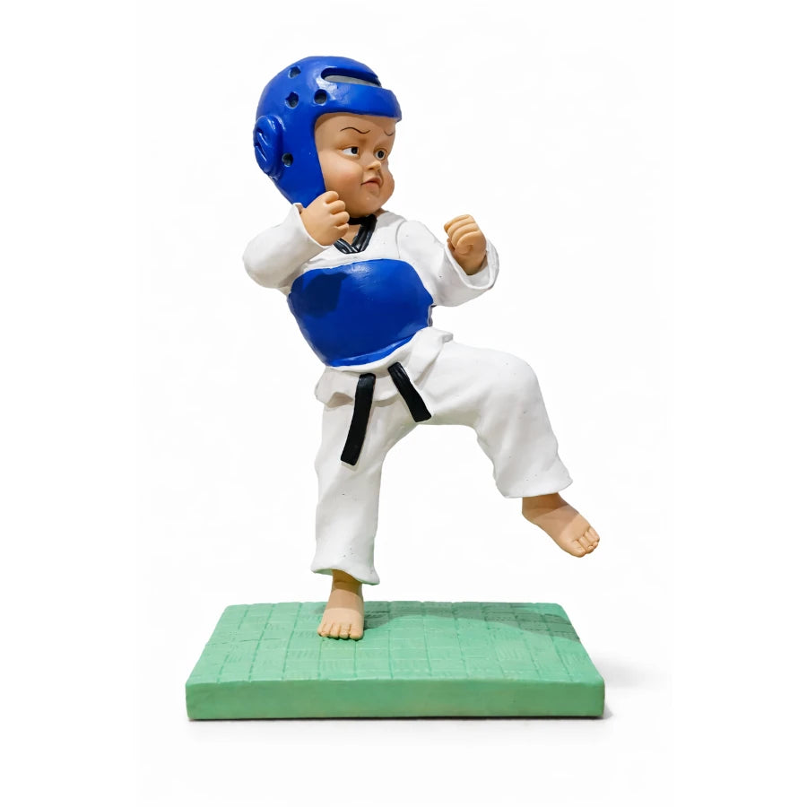 Figurine of a martial artist in blue helmet and white uniform on a green mat