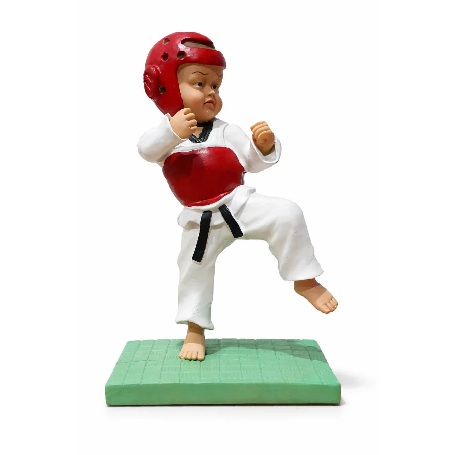 Figurine of a martial artist in a red helmet and white outfit on a green mat with a white background
