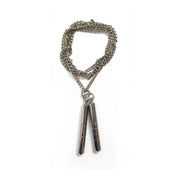 Silver chain bracelet with nunchucku pendant on a white background