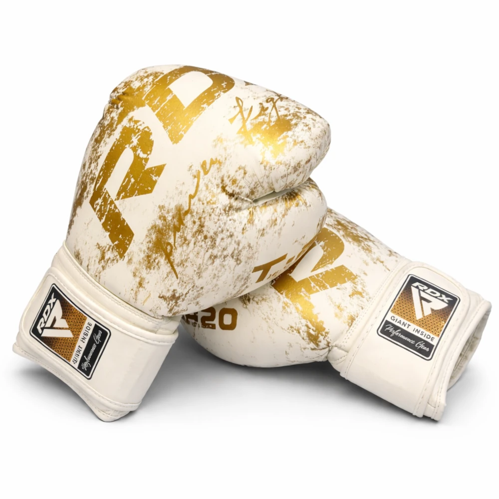 Pair of white and gold RDX boxing gloves with visible branding on a white background