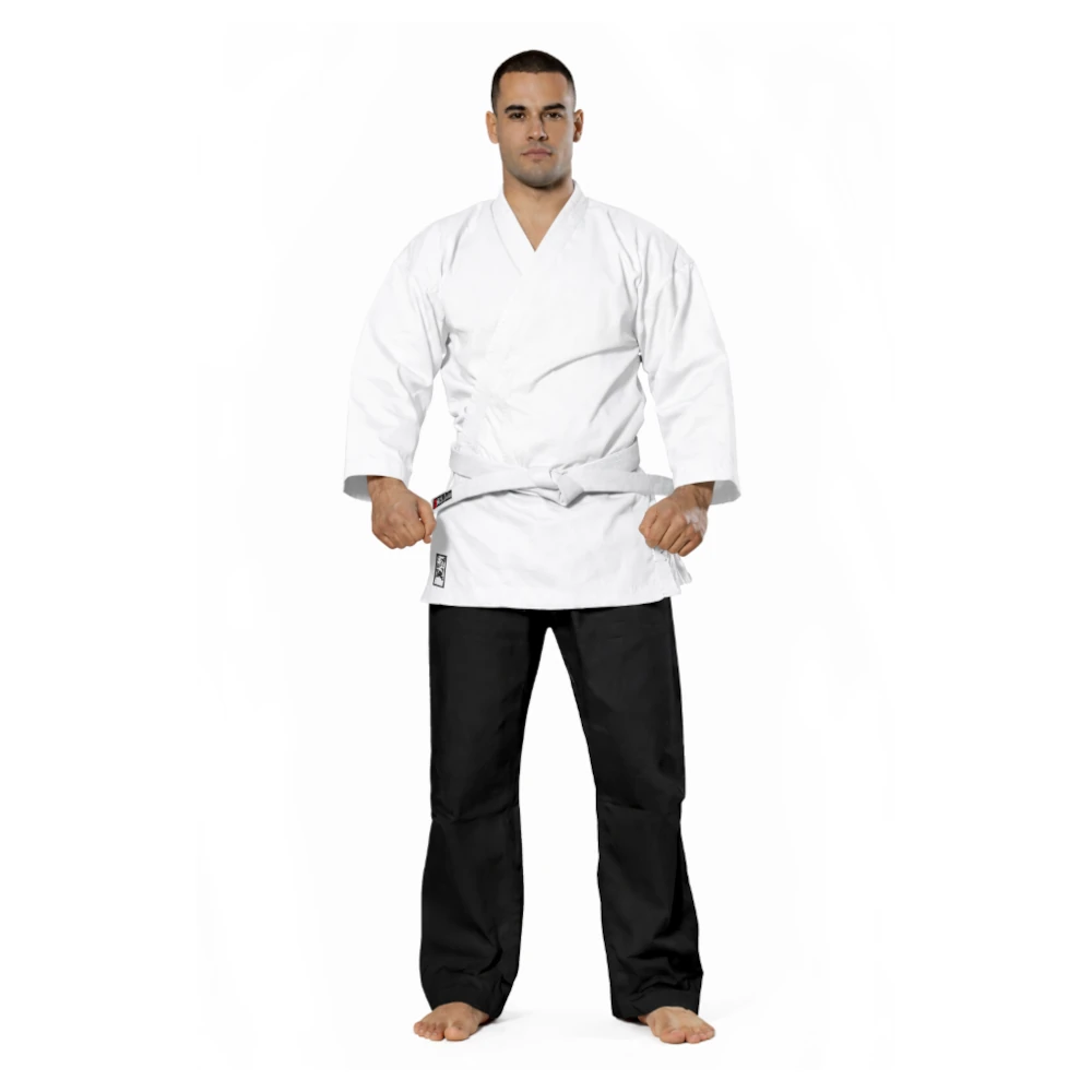 Man wearing a white martial arts uniform with black pants on a white background