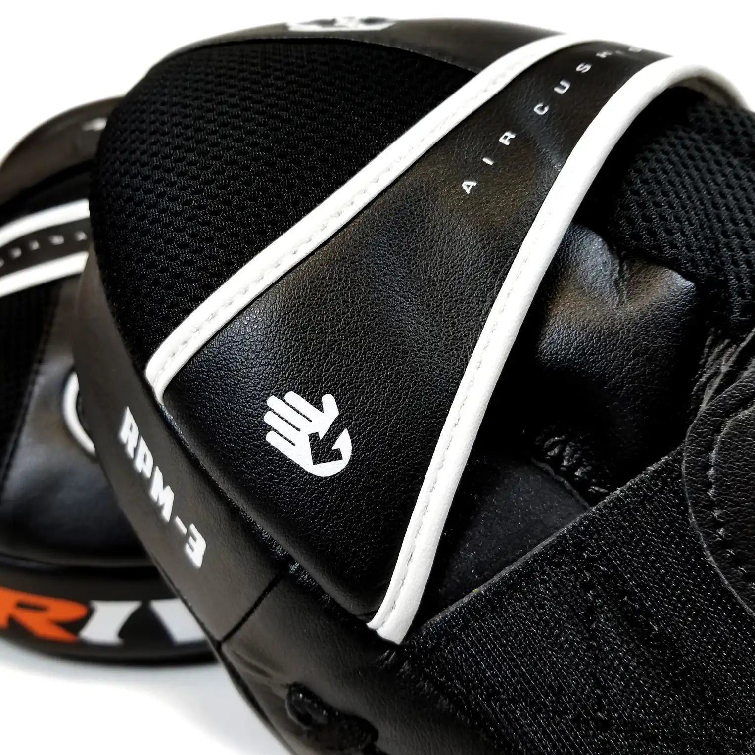 Close-up of a black focus mitt with white accents and visible Rival branding on a white background