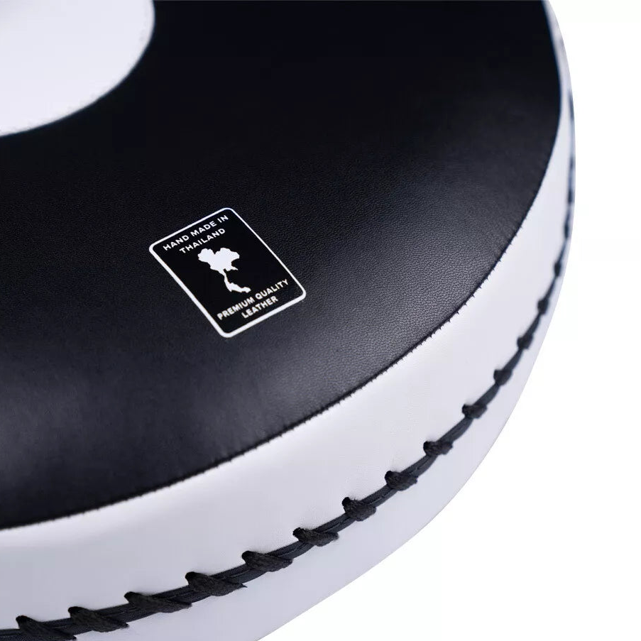 Close-up of a black and white boxing pad with a 'Hand Made in Thailand' label.