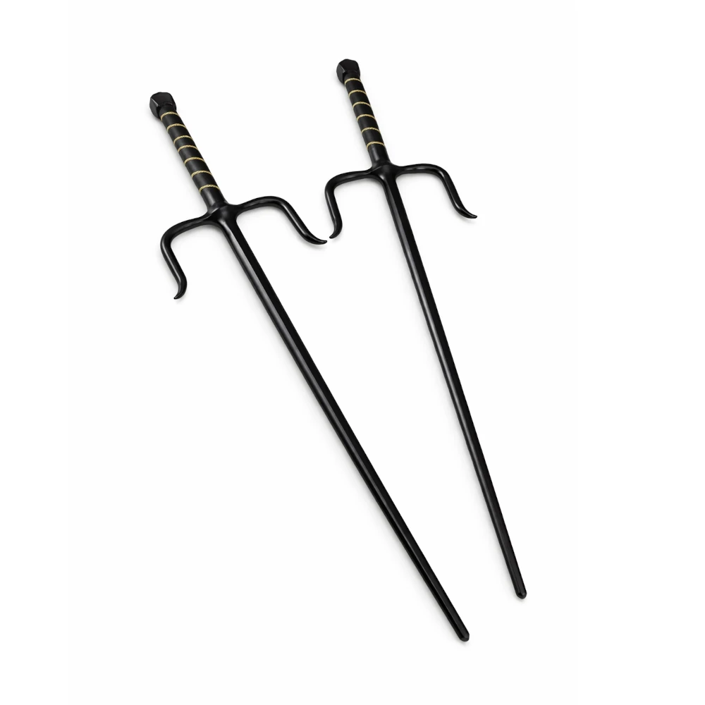 Two black sai swords with decorative handles on a white background
