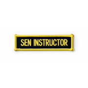 Embroidered patch with 'SEN INSTRUCTOR' text on a black background