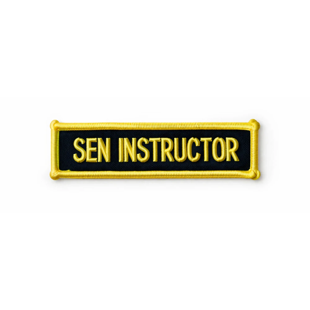 Embroidered patch with 'SEN INSTRUCTOR' text on a black background