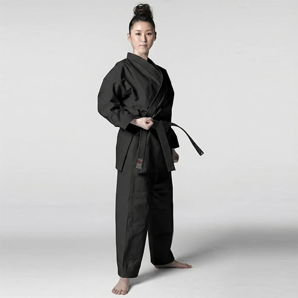 Woman wearing a black martial arts uniform on a white background