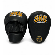 Pair of black and gold SKS Thailand boxing mitts on a white background