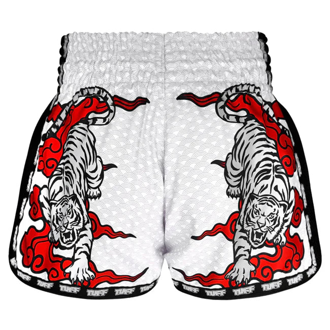 White Muay Thai shorts with red and black tiger design on a white background