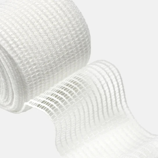 One roll of white mesh gauze on a light gray background