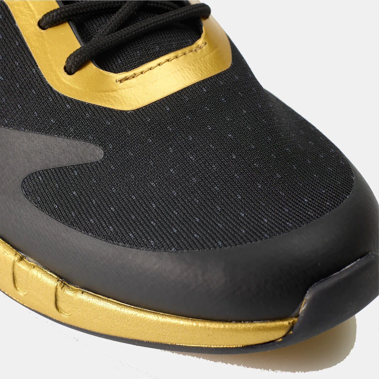 Black and gold sneaker with a focus on the end profile.