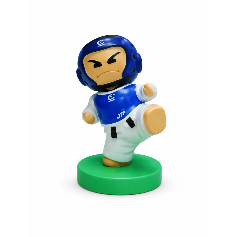 Figurine of a character in a blue helmet and white outfit on a green base against a white background