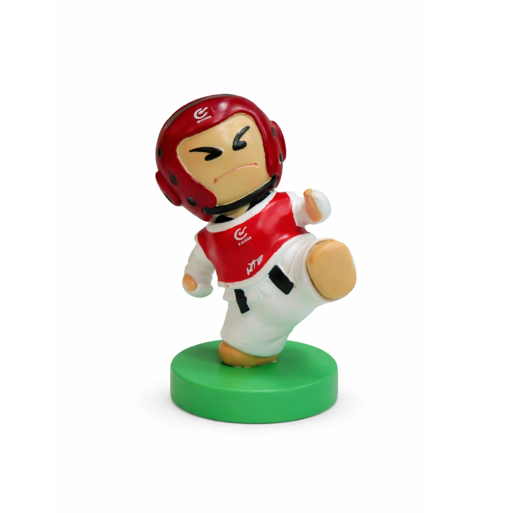Toy figure of a martial artist in a red helmet and white outfit on a green base against a white background