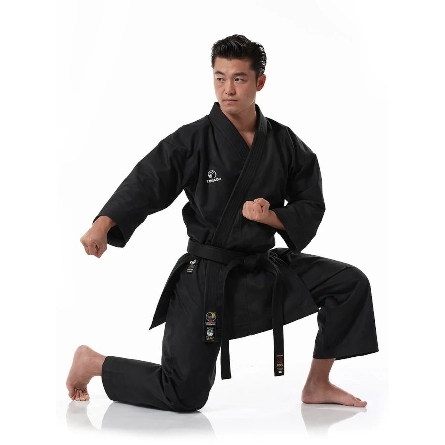 Person wearing a black Tokaido martial arts uniform on a white background