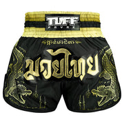 Black and gold Muay Thai shorts with dragon designs and TUFF PAYAK branding.
