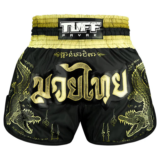 Black and gold Muay Thai shorts with dragon designs and TUFF PAYAK branding.