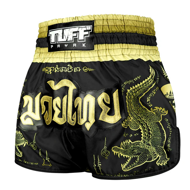 Black and gold Muay Thai shorts with crocodile design and TUFF PAYAK branding.