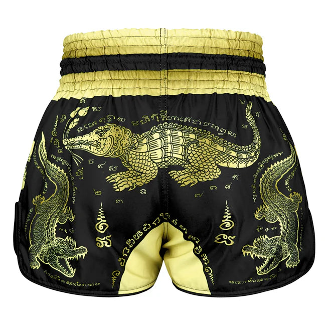 Black shorts with gold crocodile design on a white background