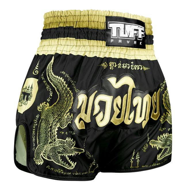Black and gold Muay Thai shorts with dragon design and TUFF label on a white background