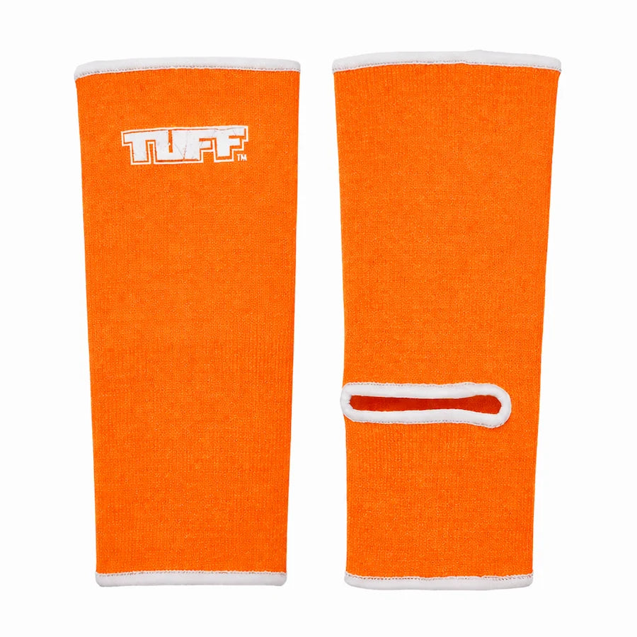 Pair of orange Tuff ankle guards with white accents on a white background