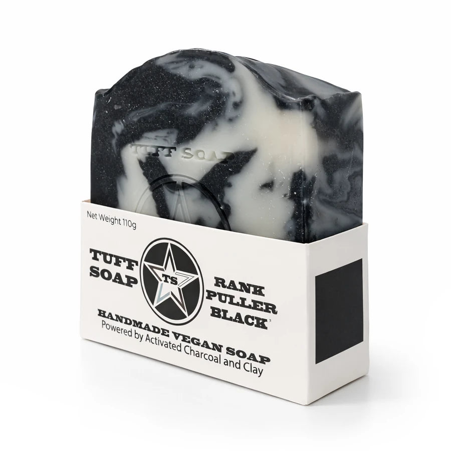 Black and white swirled soap bar in a Tuff Soap packaging on a white background