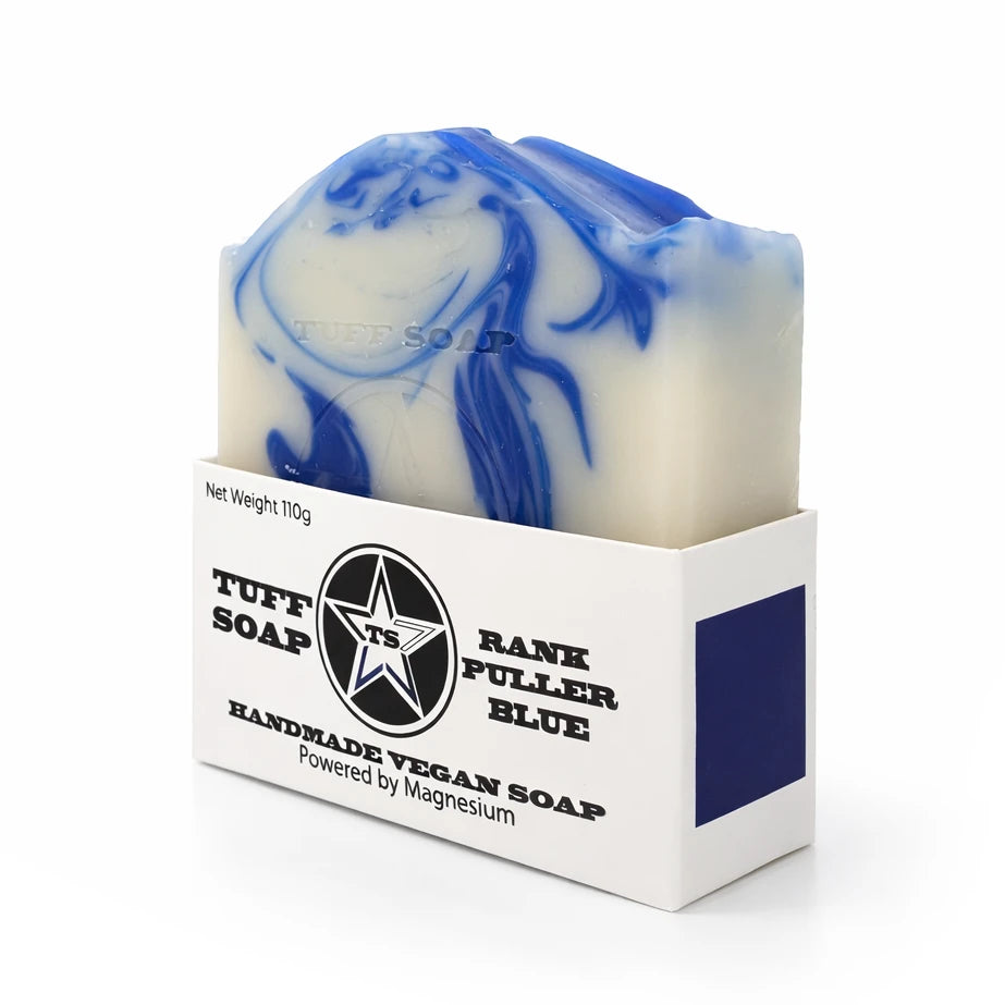 Bar of soap with blue and white swirls in a branded box on a white background