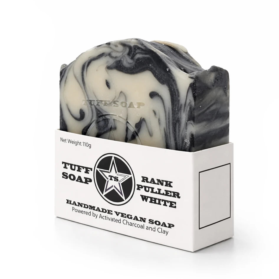 Black and white swirled soap bar with Tuff Soap packaging on a white background