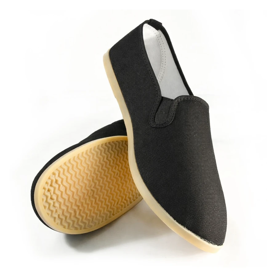 Black slip-on kung fu shoes with yellow soles on a white background