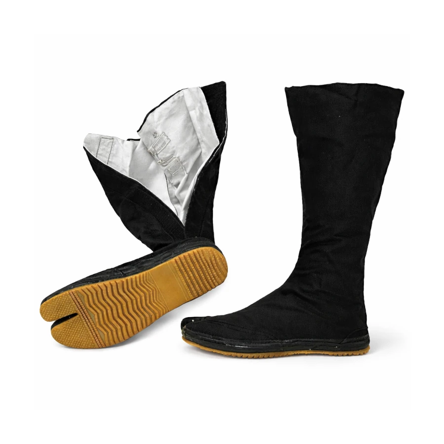 Black tabi boots with yellow soles on a white background