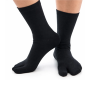 Black tabi socks worn on a white background