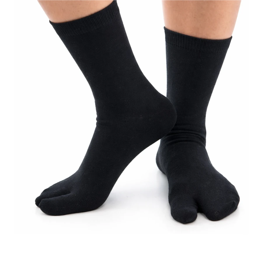 Black tabi socks worn on a white background