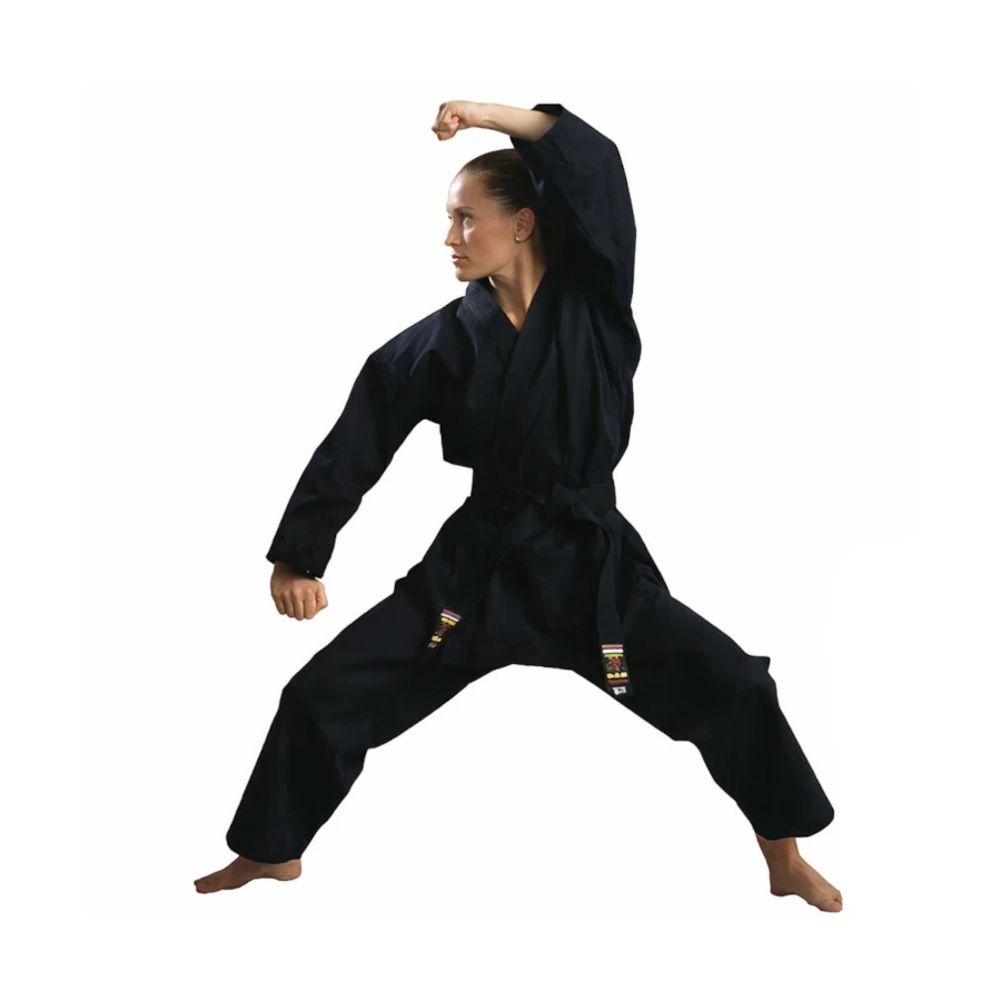 Woman in a black martial arts uniform performing a pose on a white background
