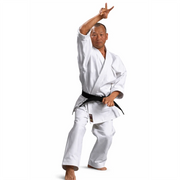 Male in a white martial arts uniform with a black belt on a white background