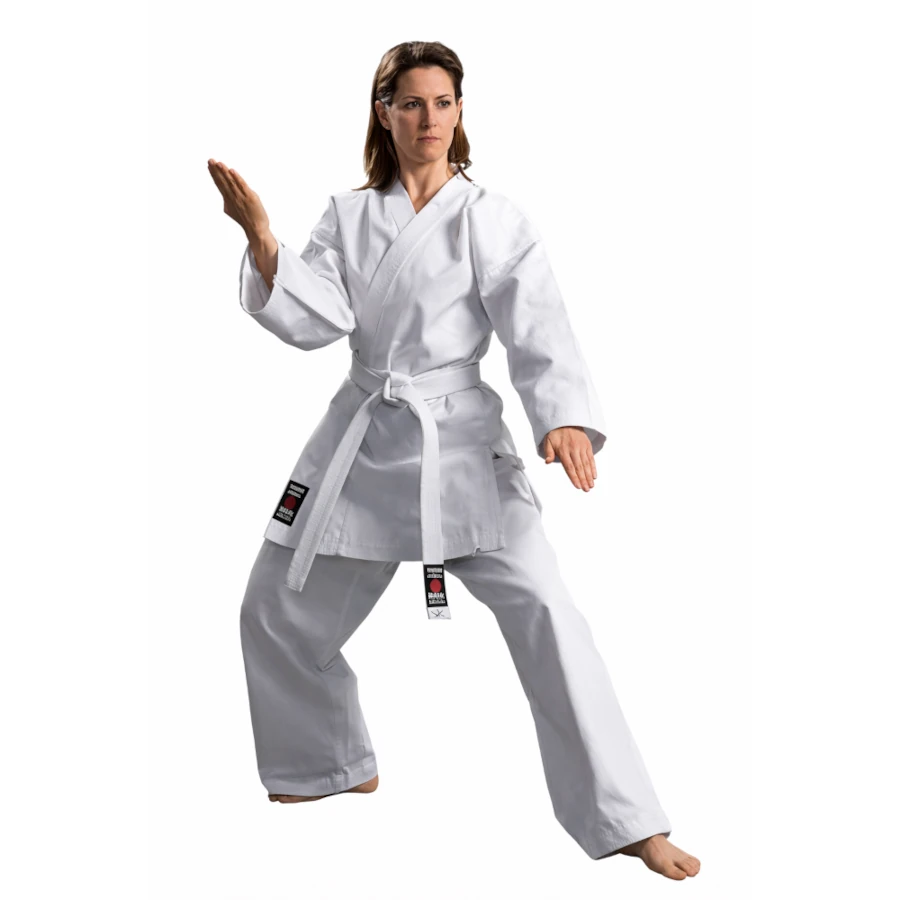 Woman wearing a white martial arts uniform on a white background