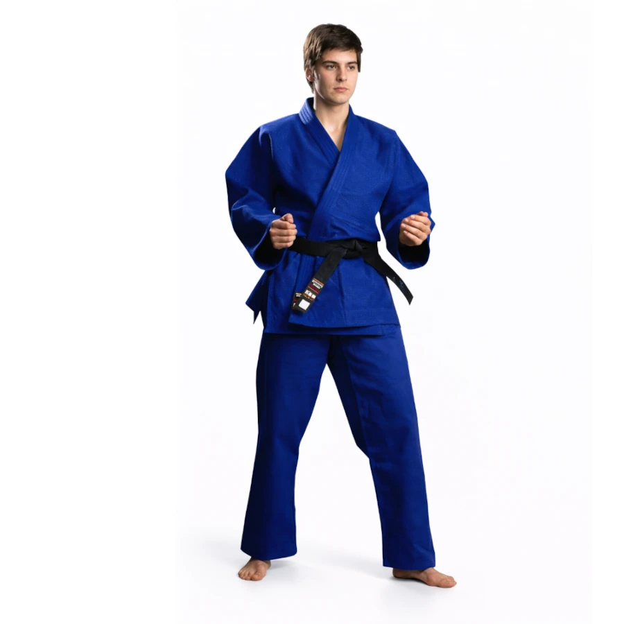 Male wearing a blue martial arts uniform with a black belt on a white background
