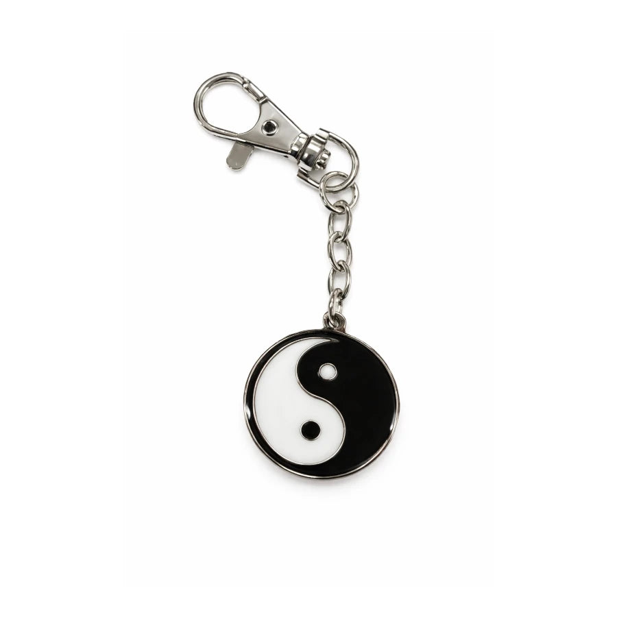 Yin yang symbol keychain on a white background